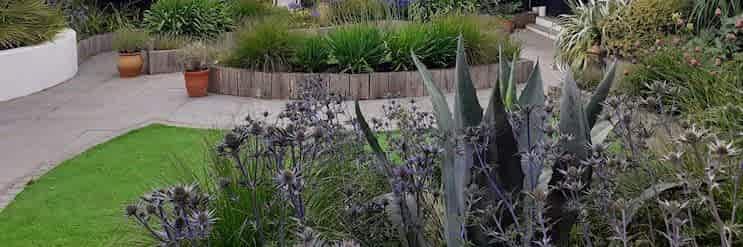 Garden design in Ascot, Berkshire with raised beds and artificial grass.