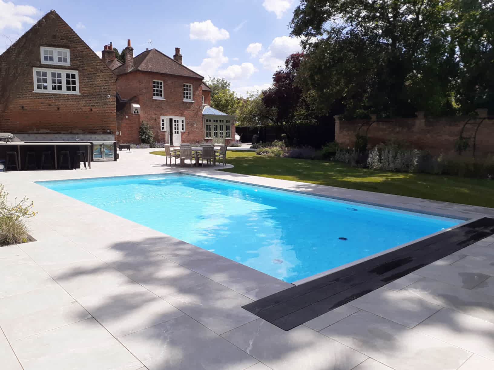 Garden design in Windsor Berkshire with swimming pool and outdoor kitchen