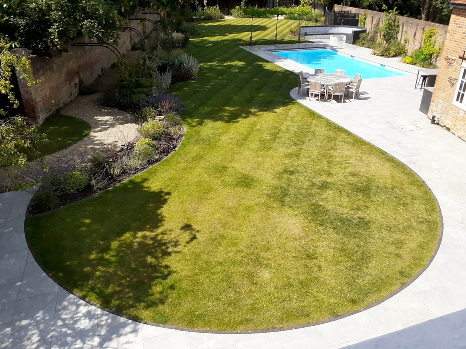 Garden design in Windsor Berkshire with swimming pool and outdoor kitchen